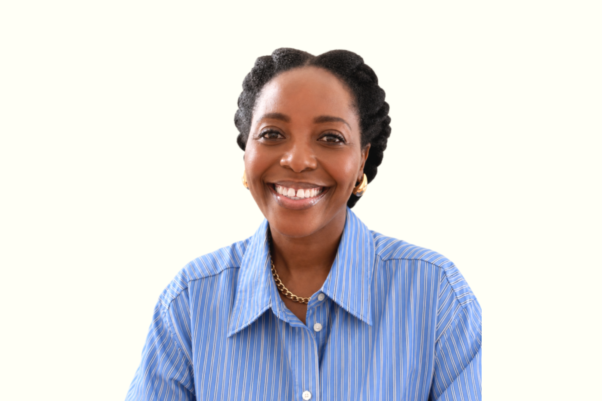 Vashti Patrick-Joseph smiling in a blue striped shirt