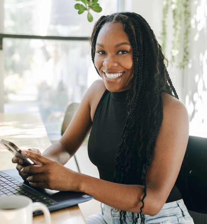 and Product M… Ashantia smiling outdoors in a black top